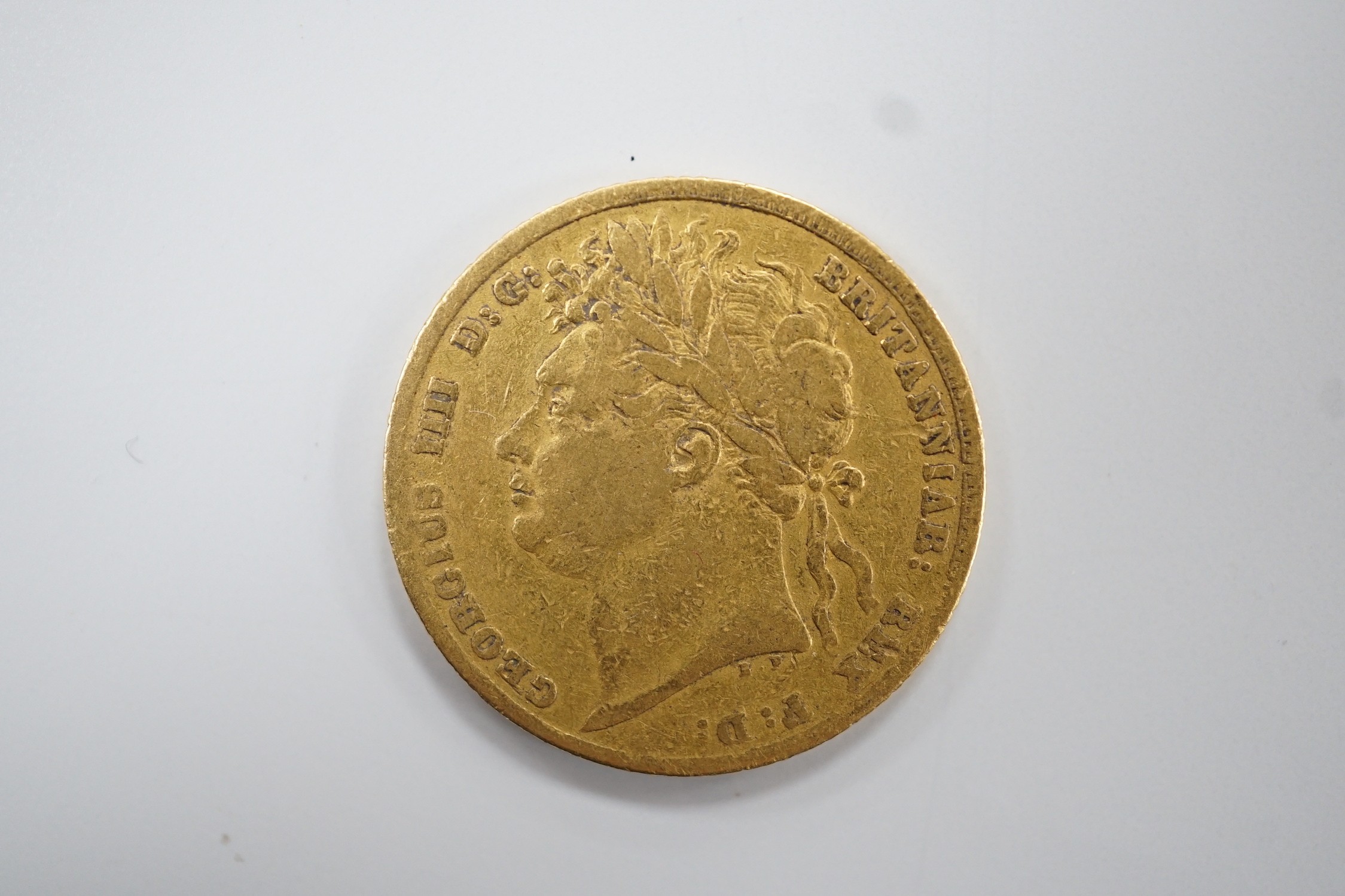 A George IV 1824 gold sovereign, VG or better.